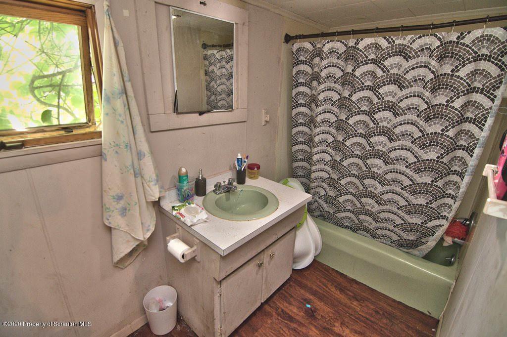 1716 Wayne Avenue Scranton, PA 18508 - Photo 27 of 42 a bathroom with a sink toilet and a window