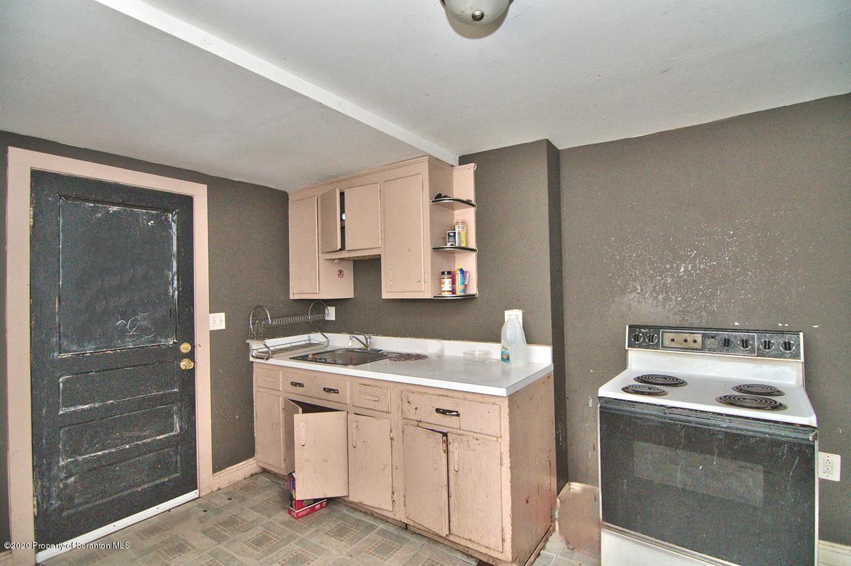 1716 Wayne Avenue Scranton, PA 18508 - Photo 33 of 42 a kitchen with a stove sink and cabinets