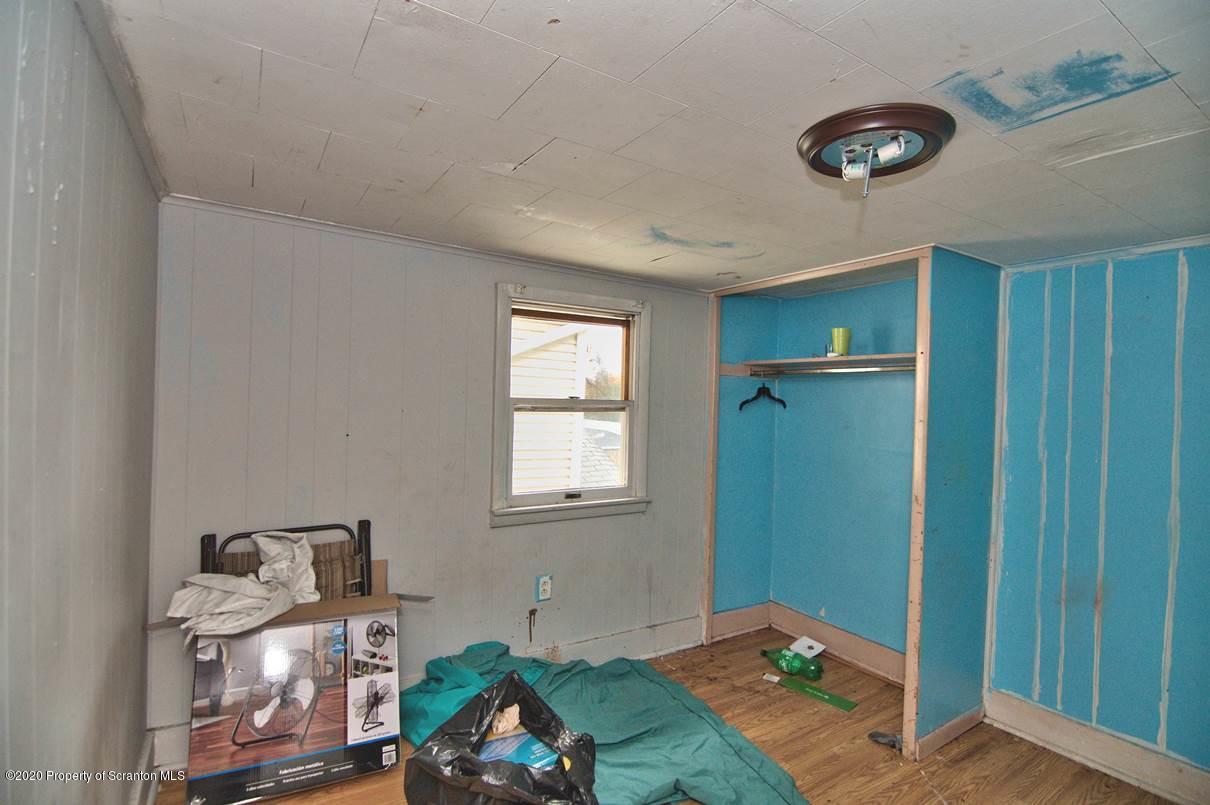 1716 Wayne Avenue Scranton, PA 18508 - Photo 36 of 42 a bedroom with a bed and a chandelier