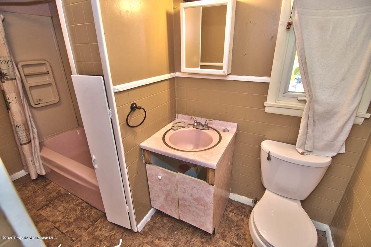 1716 Wayne Avenue Scranton, PA 18508 - Photo 37 of 42 a bathroom with a toilet a sink and a mirror