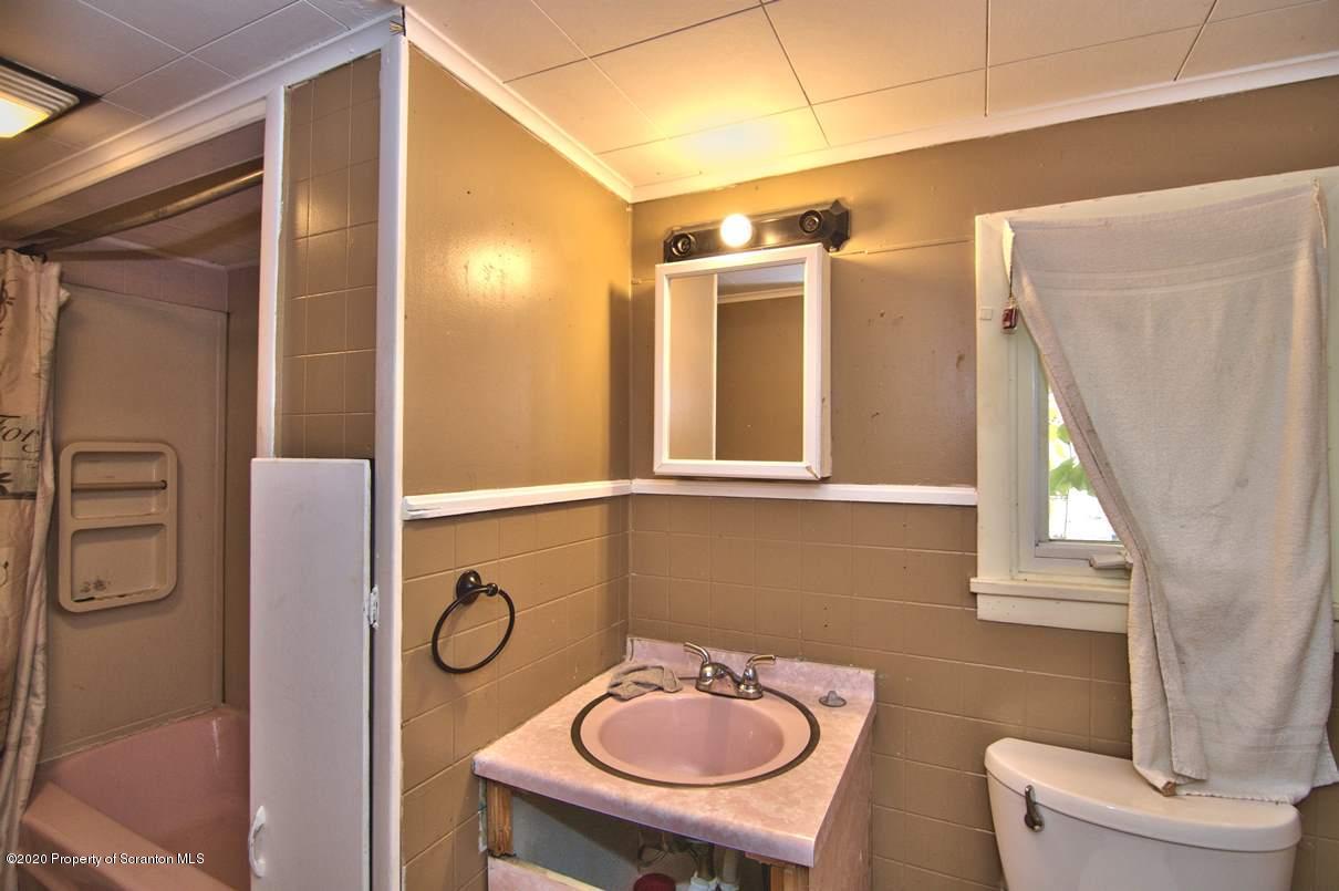 1716 Wayne Avenue Scranton, PA 18508 - Photo 38 of 42 a bathroom with a toilet a sink and mirror