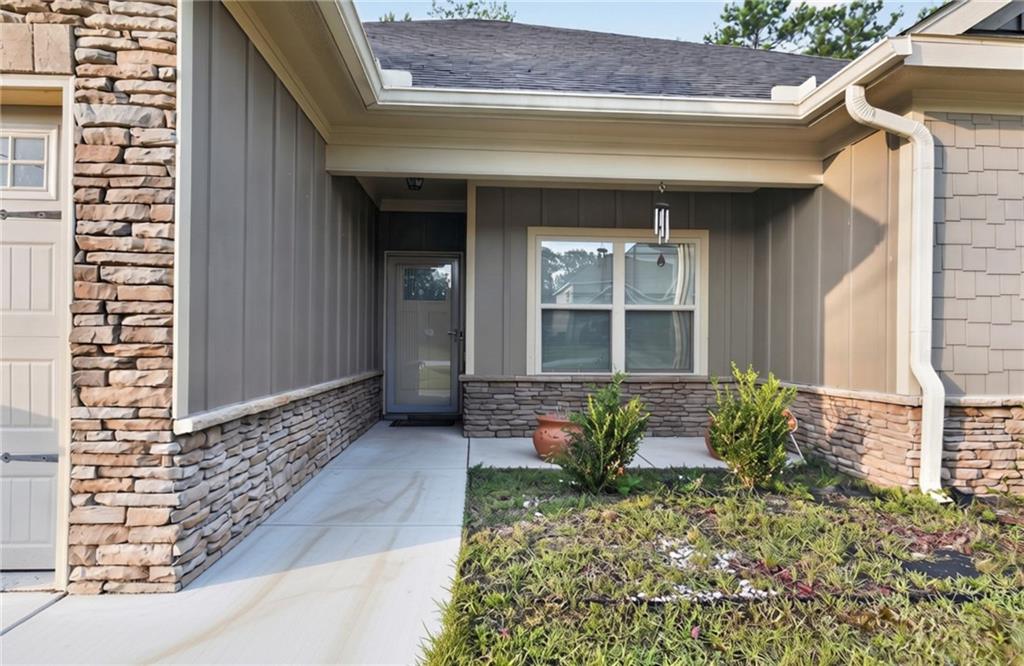 5 Fast Lane Seale, AL 36875 - Photo 2 of 13 Welcoming covered entry with mixed-material exterior featuring stacked stone and horizontal siding accents