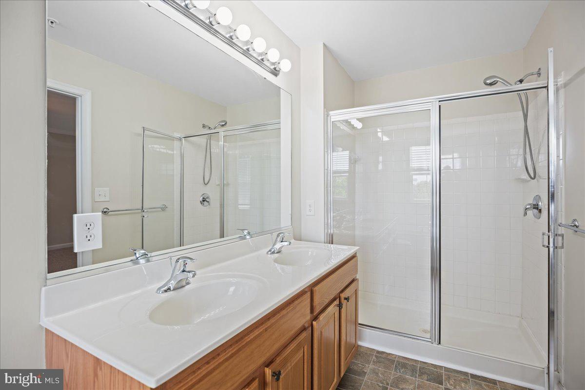 126 Backstretch Way Prince Frederick, MD 20678 - Photo 31 of 49 a bathroom with a double vanity sink mirror and shower