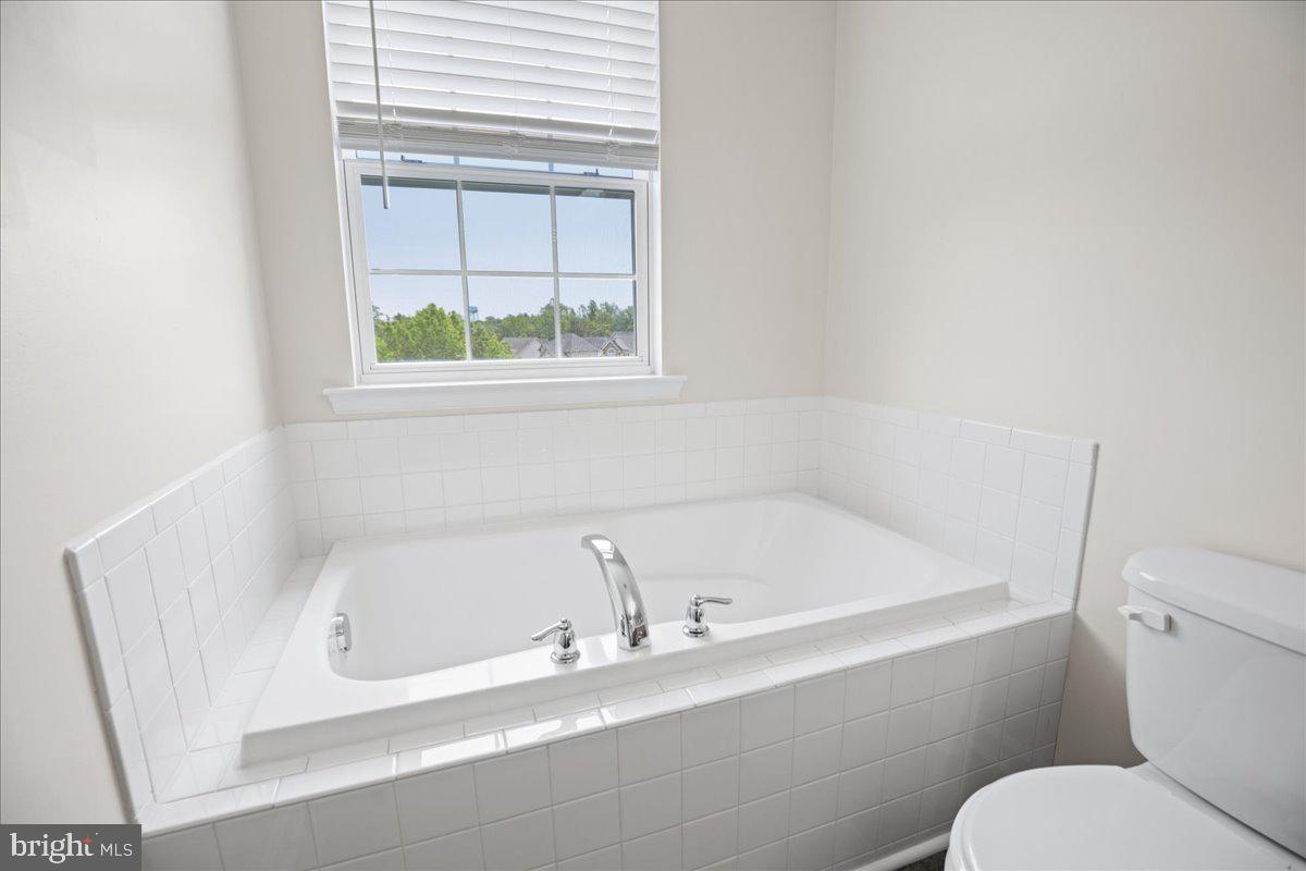126 Backstretch Way Prince Frederick, MD 20678 - Photo 32 of 49 a white bath tub sitting next to a toilet