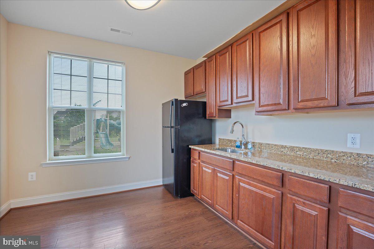 126 Backstretch Way Prince Frederick, MD 20678 - Photo 48 of 49 a kitchen with stainless steel appliances granite countertop a refrigerator sink and cabinets