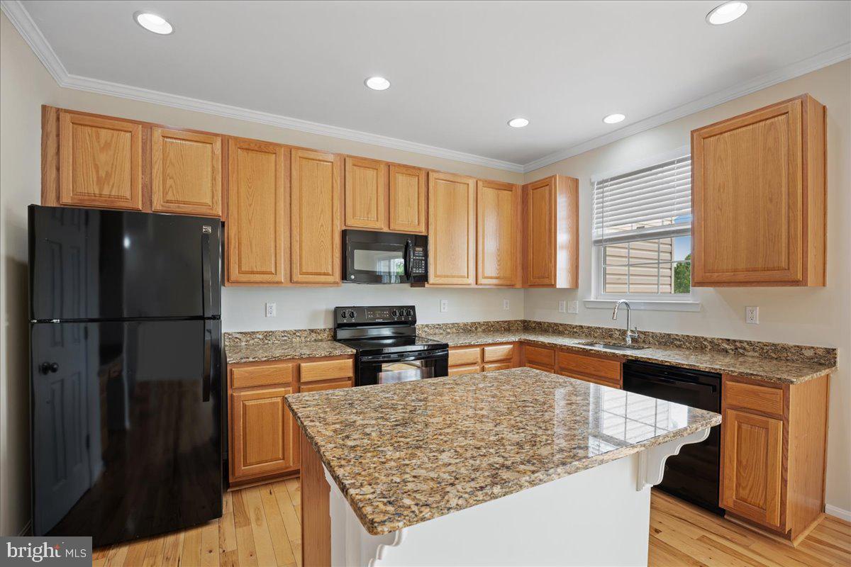 126 Backstretch Way Prince Frederick, MD 20678 - Photo 10 of 49 a kitchen with stainless steel appliances granite countertop a refrigerator sink stove microwave and cabinets