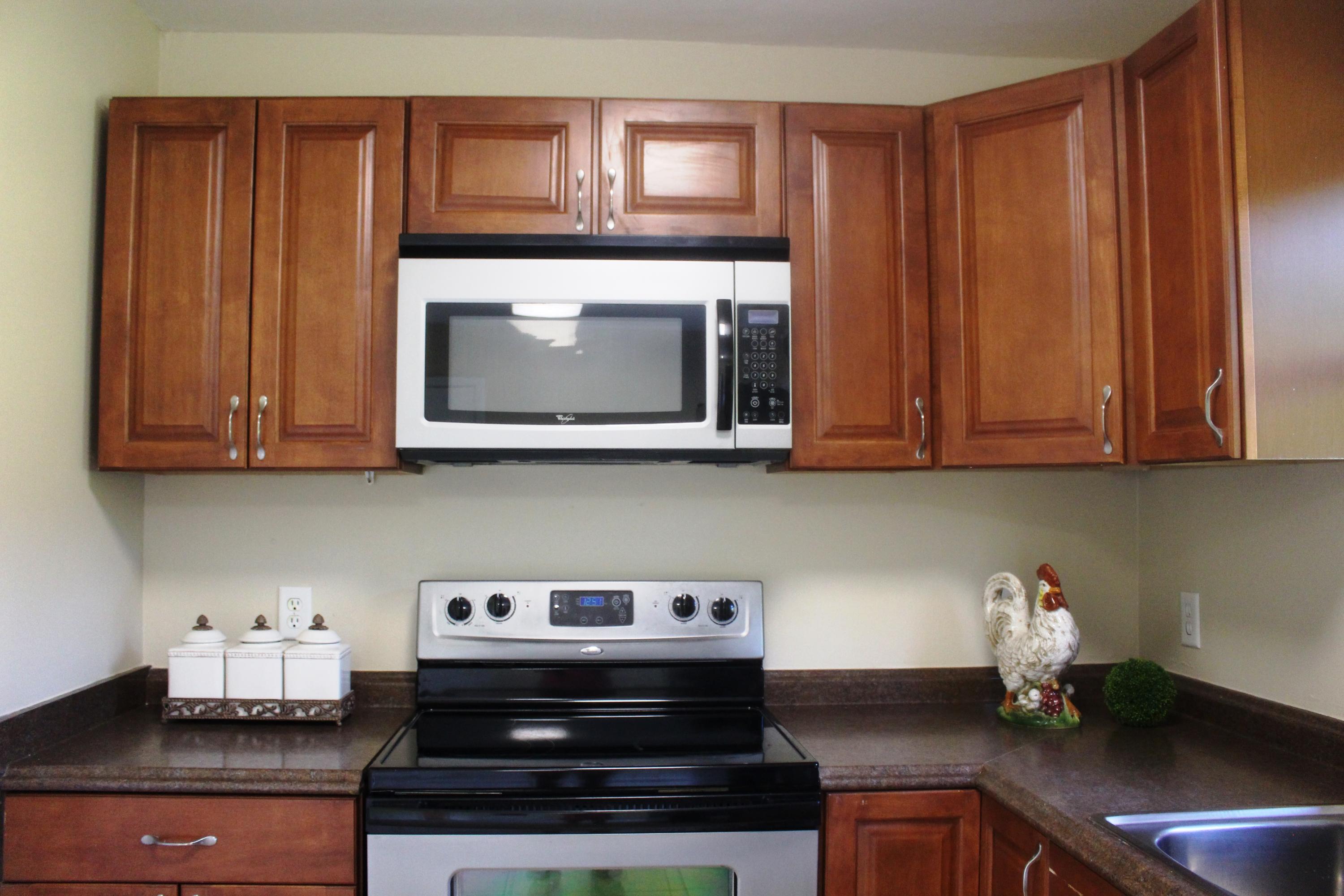 6160 Old Hickory Road Crestview, FL 32539 - Photo 2 of 12 a kitchen with stainless steel appliances granite countertop a stove a microwave and cabinets