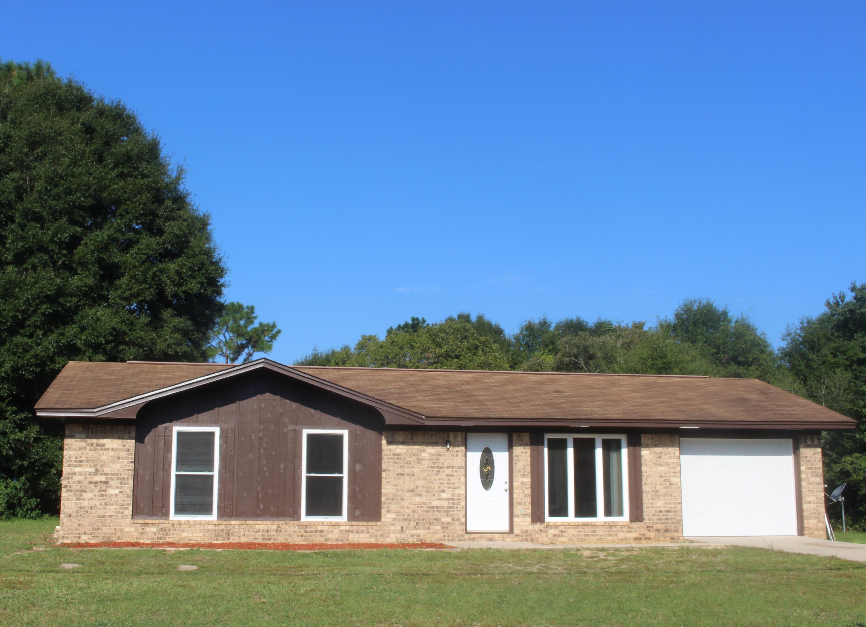6160 Old Hickory Road Crestview, FL 32539 - Photo 11 of 12 a front view of a house with a garden