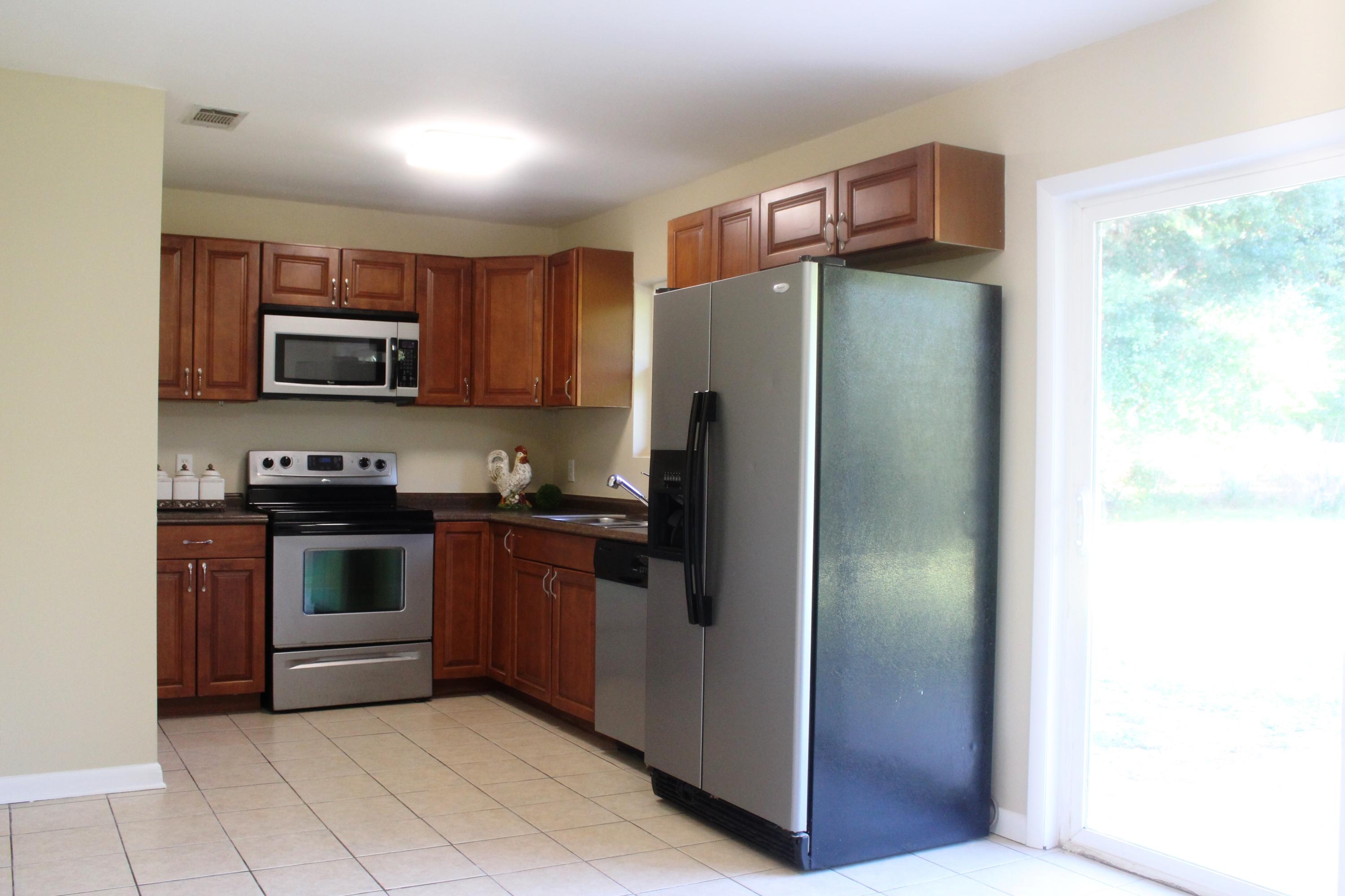 6160 Old Hickory Road Crestview, FL 32539 - Photo 4 of 12 a kitchen with granite countertop a refrigerator and a stove top oven