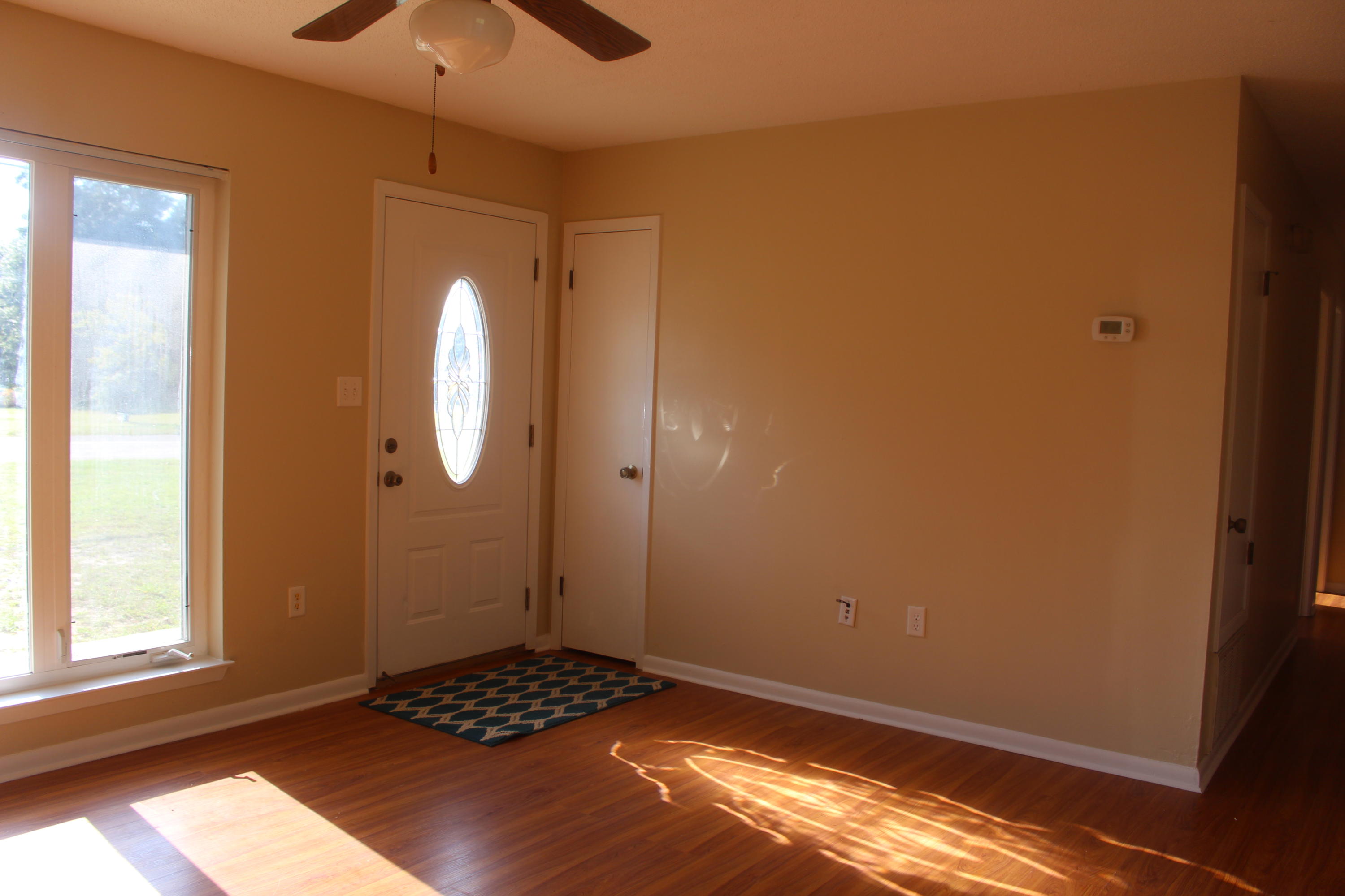 6160 Old Hickory Road Crestview, FL 32539 - Photo 7 of 12 a view of a livingroom with wooden floor and a window