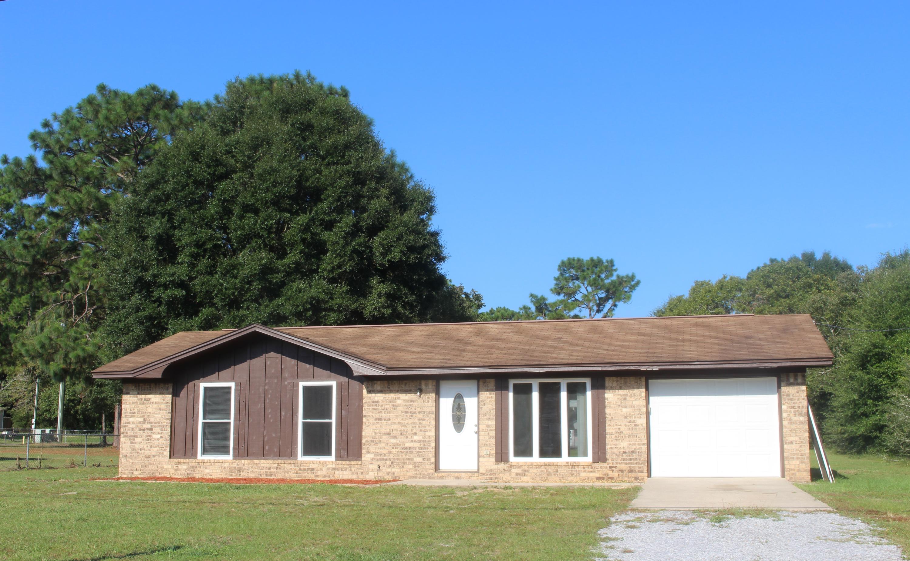 6160 Old Hickory Road Crestview, FL 32539 - Photo 10 of 12 a front view of a house with a garden