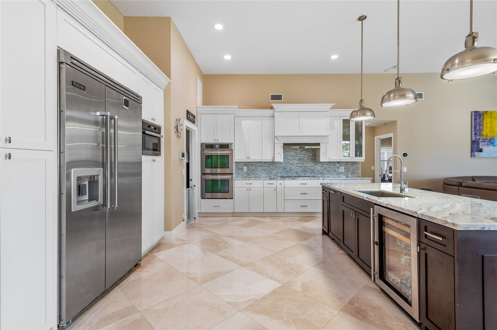 20220 Ocean Key Drive Boca Raton, FL 33498 - Photo 3 of 43 a large kitchen with stainless steel appliances kitchen island granite countertop a refrigerator and a sink