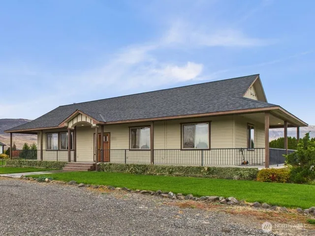 a front view of a house with a garden and yard