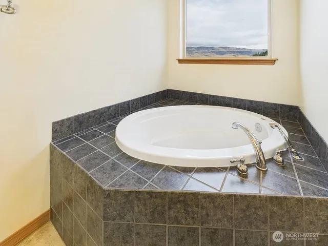 a bathroom with a tub shower and sink