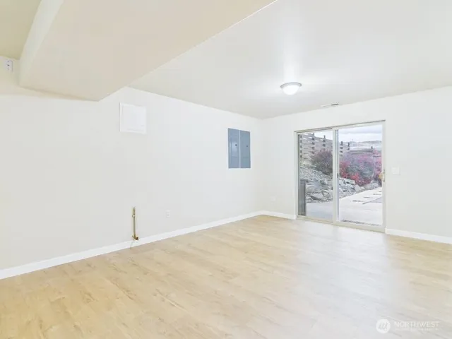an empty room with cabinet and mirrors