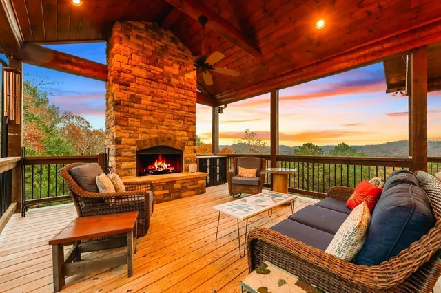 a balcony with furniture and a fireplace