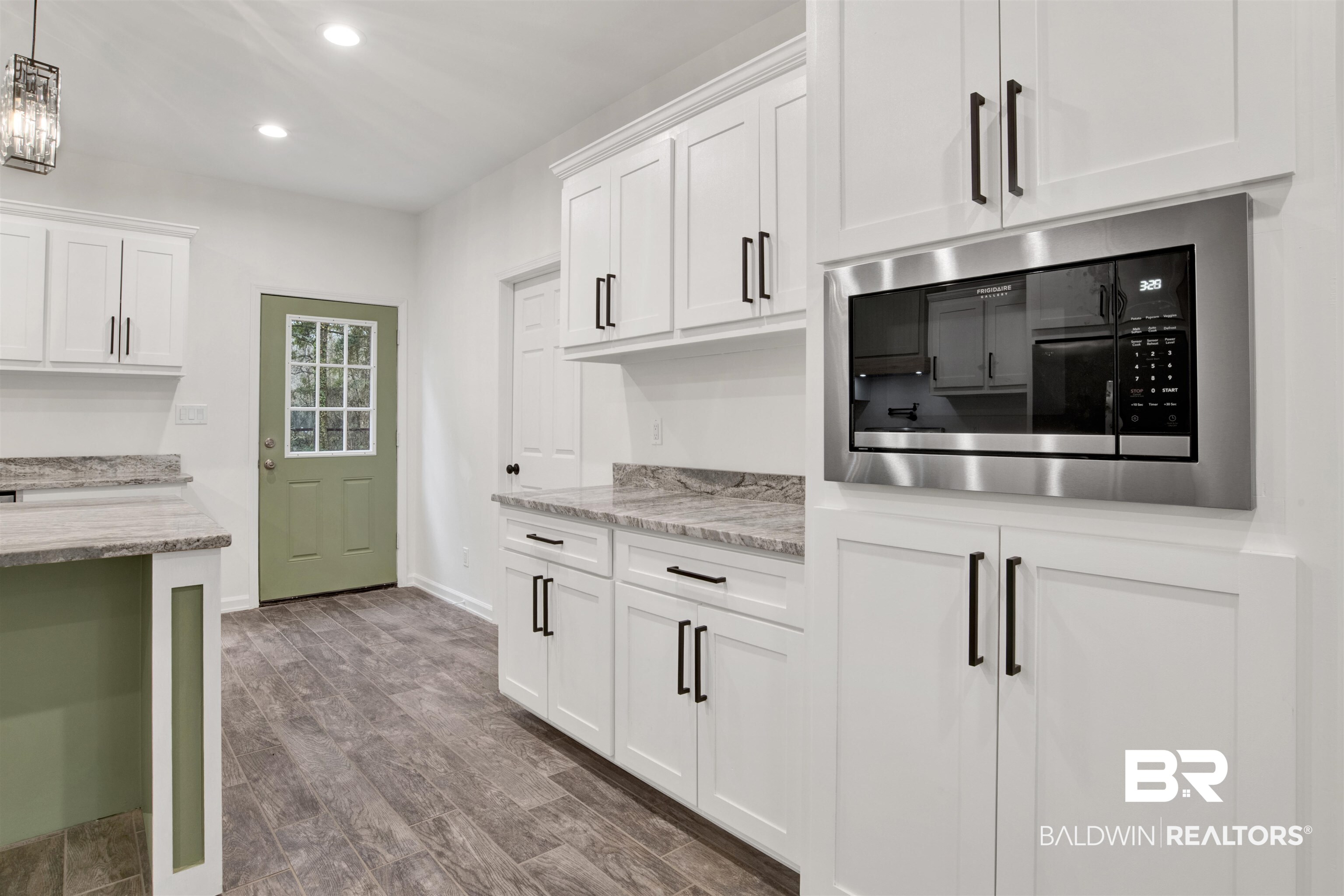 10871 Somerset Road Grand Bay, AL 36541 - Photo 15 of 31 Kitchen with built in microwave, white cabinets, and light stone countertops
