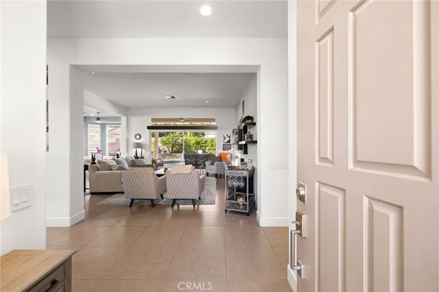 a living room with furniture a flat screen tv and a floor to ceiling window
