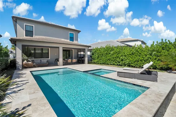 a view of a house with backyard sitting area and garden