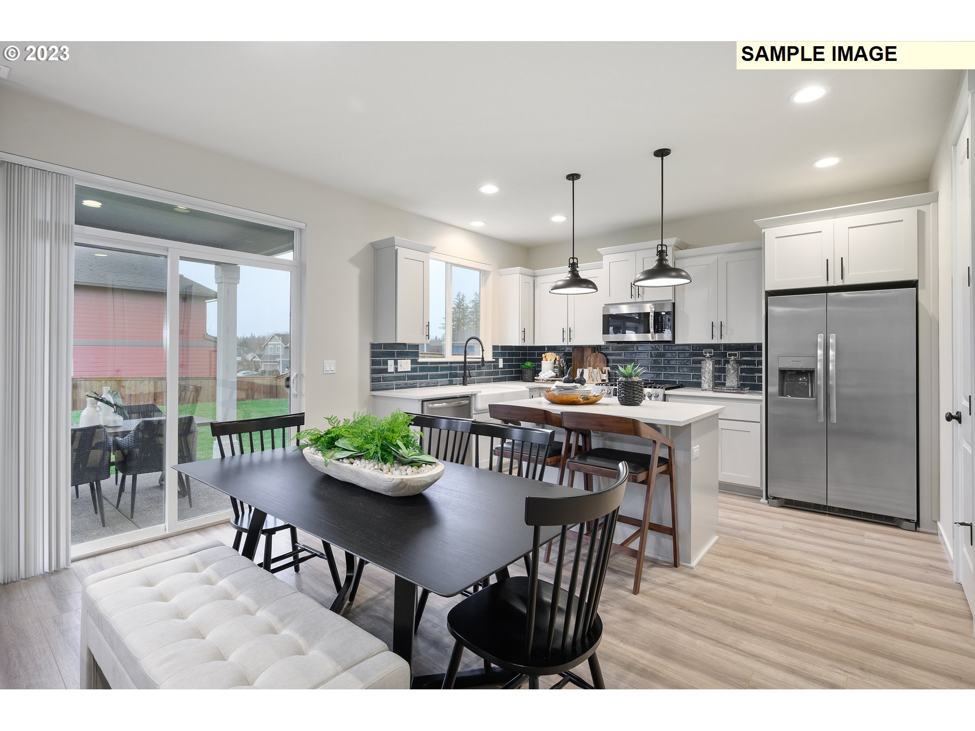 733 North Russet Place, Unit 193 Ridgefield, WA 98642 - Photo 21 of 34 a open kitchen with stainless steel appliances kitchen island granite countertop a dining table chairs and white cabinets