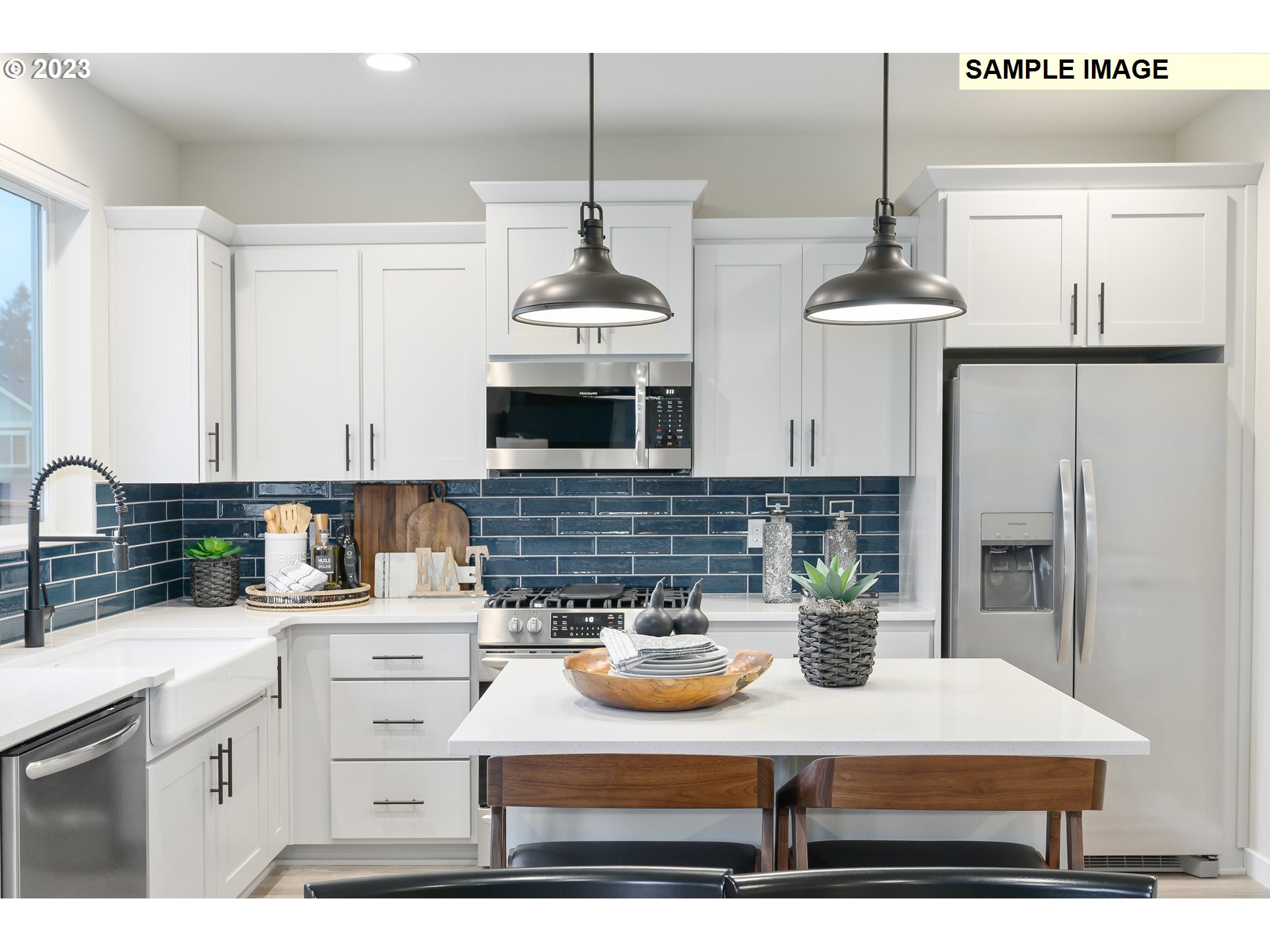 733 North Russet Place, Unit 193 Ridgefield, WA 98642 - Photo 9 of 34 a kitchen with kitchen island granite countertop a sink a stove and cabinets