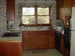 277 Battleground Road Kings Mountain, NC 28086 - Photo 5 of 8 a kitchen with a sink and wooden cabinets