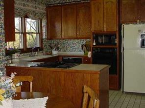 277 Battleground Road Kings Mountain, NC 28086 - Photo 6 of 8 a kitchen with a sink a refrigerator and cabinets