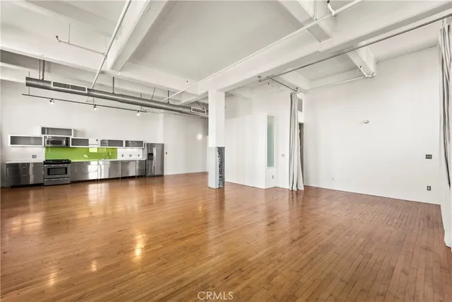 a view of a room with wooden floor
