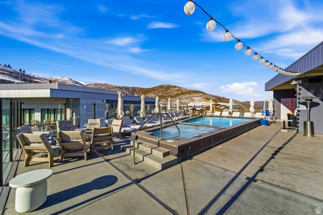 2417 West High Road, Unit 2515 Park City, UT 84098 - Photo 35 of 67 Community pool with a mountain view, a patio, and a hot tub