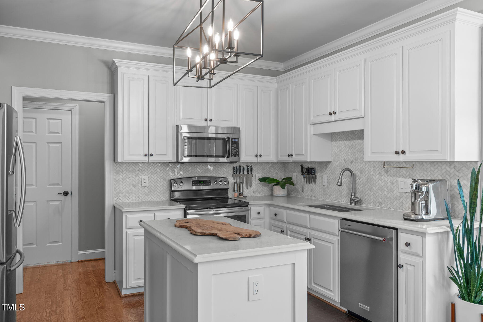 321 Commons Walk Circle Cary, NC 27519 - Photo 16 of 54 a kitchen with stainless steel appliances a white cabinets stove and refrigerator