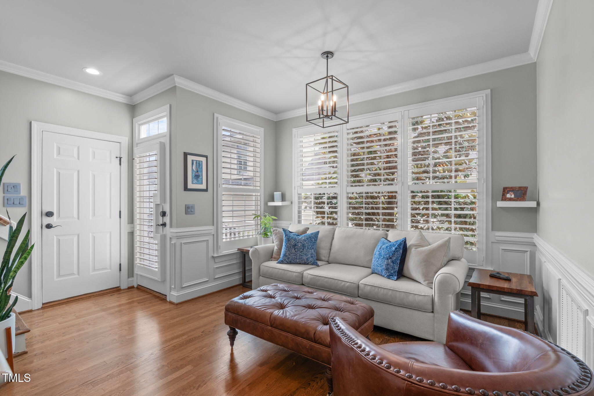 321 Commons Walk Circle Cary, NC 27519 - Photo 19 of 54 a living room with furniture and a chandelier