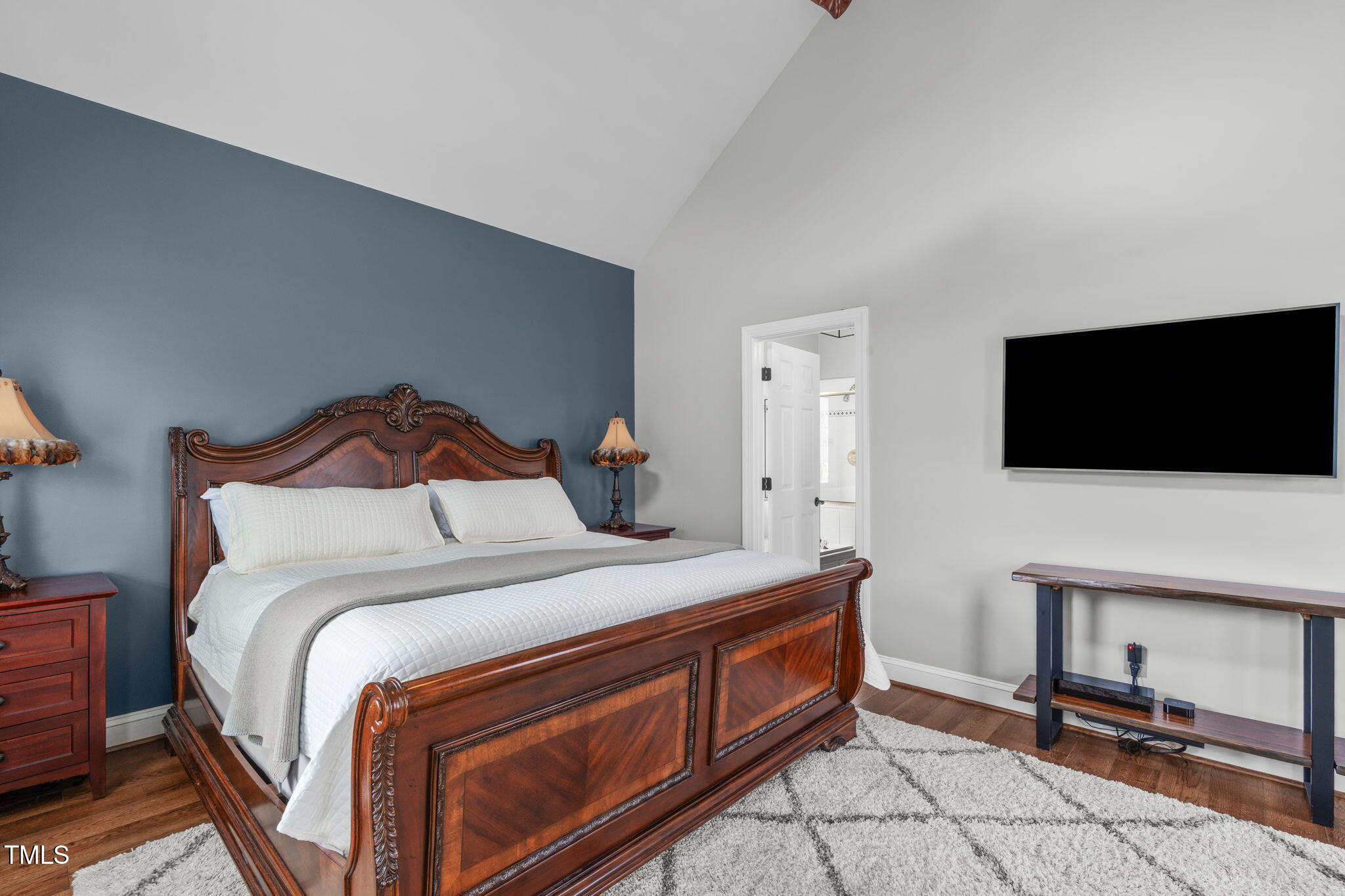 321 Commons Walk Circle Cary, NC 27519 - Photo 22 of 54 a bedroom with a bed and a flat screen tv