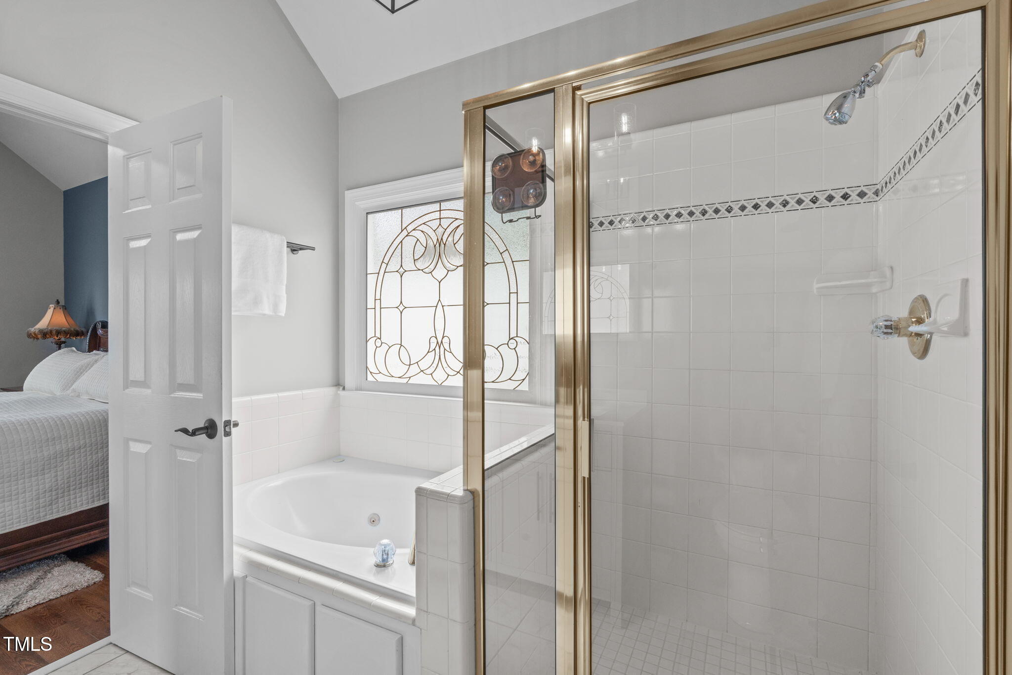 321 Commons Walk Circle Cary, NC 27519 - Photo 26 of 54 a bathroom with a shower and a tub