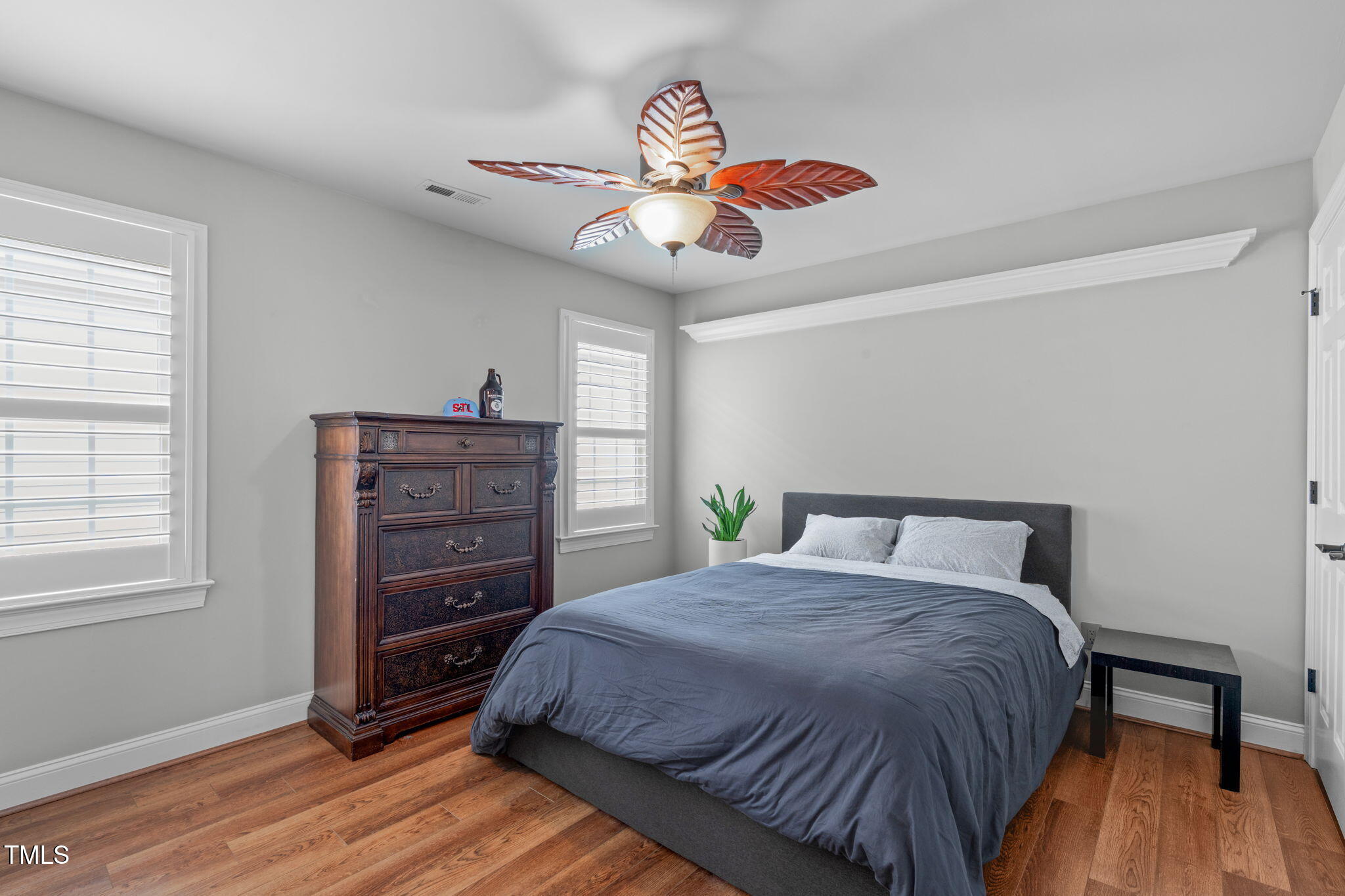 321 Commons Walk Circle Cary, NC 27519 - Photo 32 of 54 a bedroom with a bed and a dresser