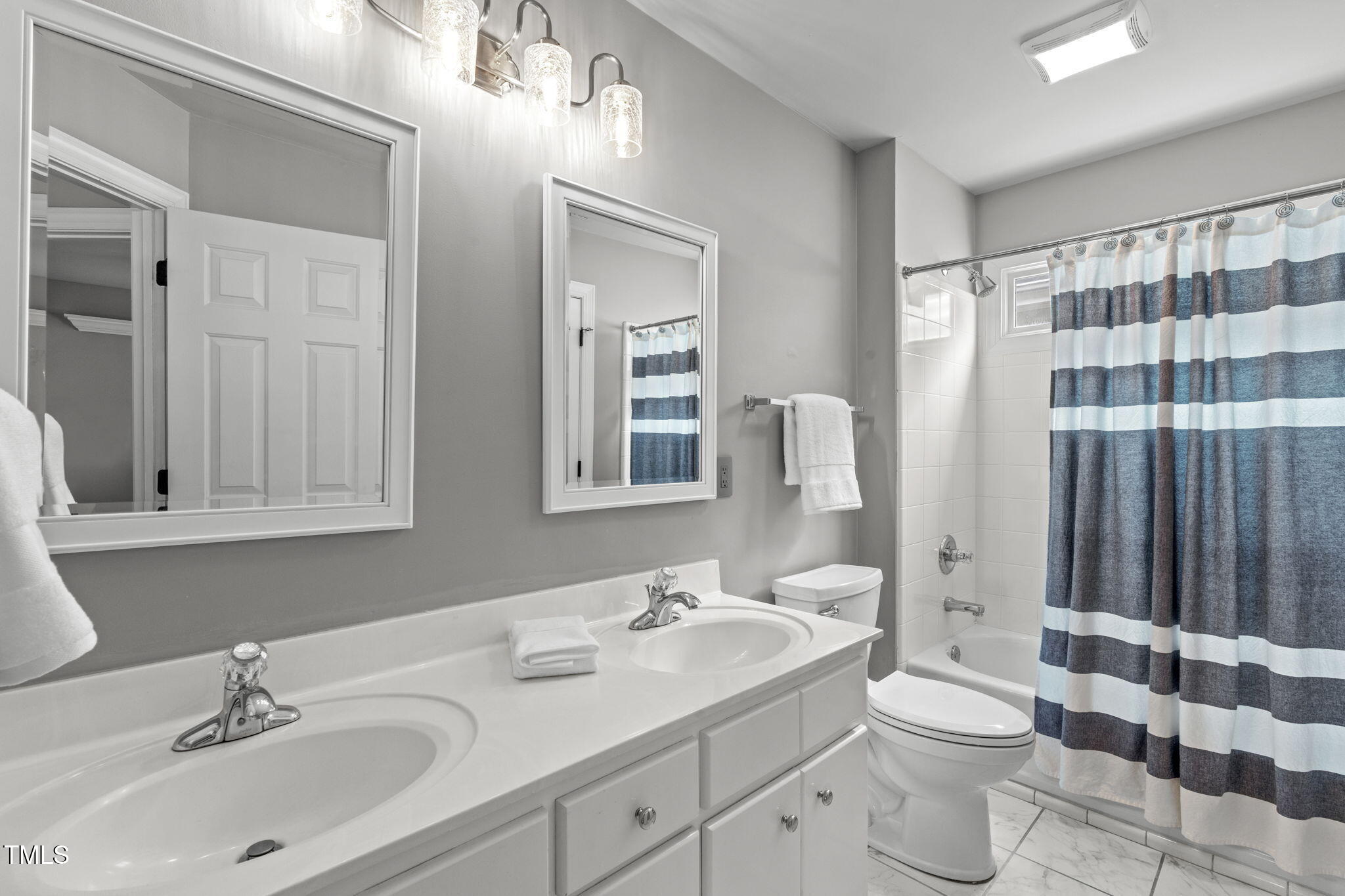 321 Commons Walk Circle Cary, NC 27519 - Photo 34 of 54 a bathroom with a double vanity sink toilet and shower