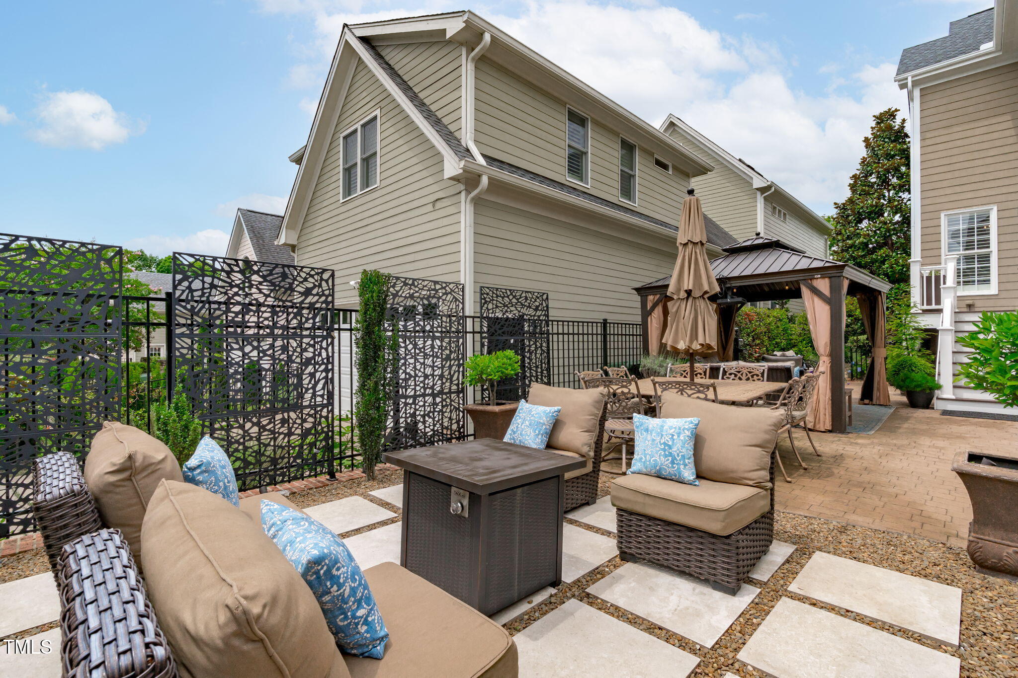 321 Commons Walk Circle Cary, NC 27519 - Photo 45 of 54 a view of a patio with couches table and chairs and potted plants
