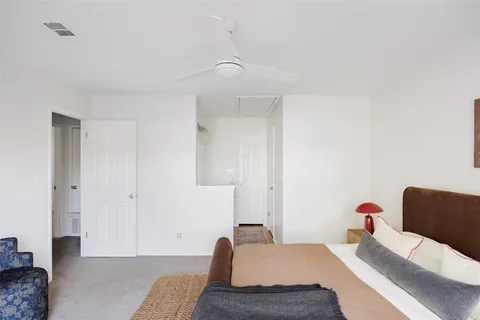 a bedroom with a bed and a couch