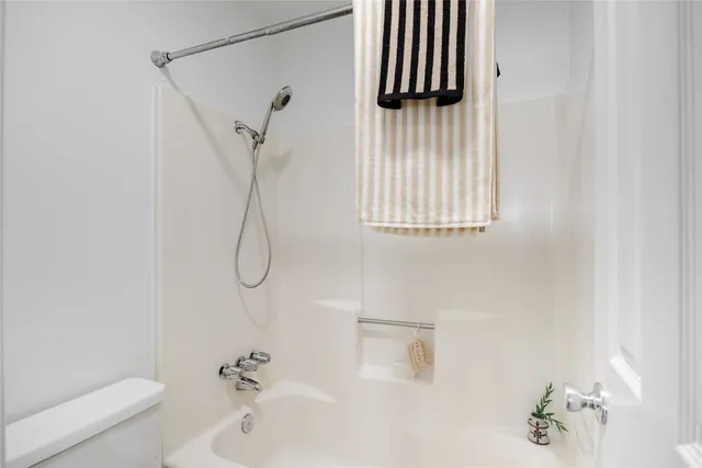 a bathroom with a shower and a toilet