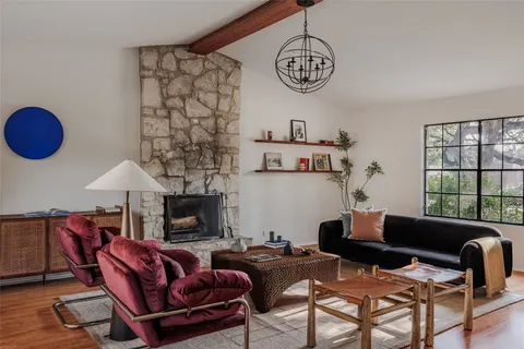 a living room with furniture a fireplace and a window