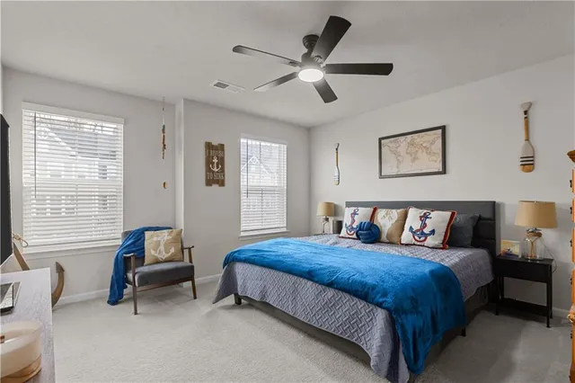 a bedroom with a bed a couch and a window