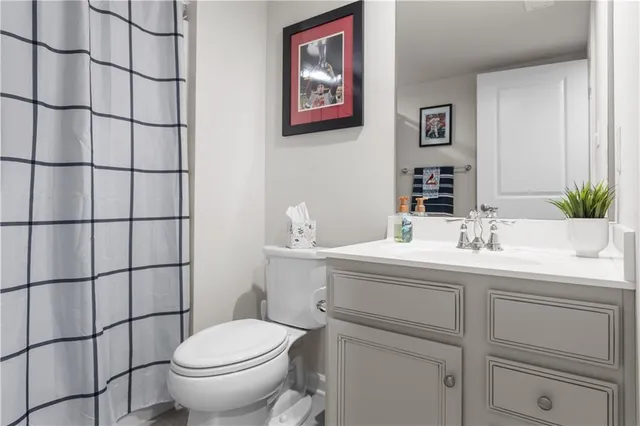 a bathroom with a sink toilet and mirror