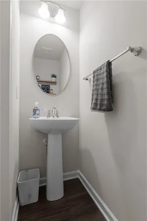 a bathroom with a sink toilet and mirror
