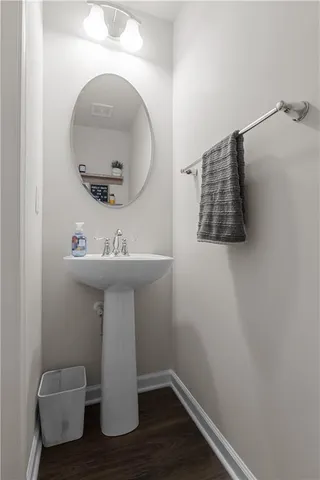 a bathroom with a sink toilet and mirror