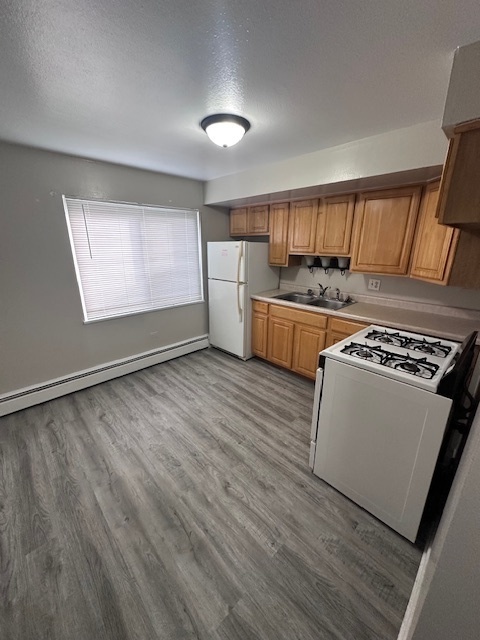 11655 South Pulaski Road, Unit 1B Alsip, IL 60803 - Photo 4 of 10 a kitchen with a stove wooden floor and window