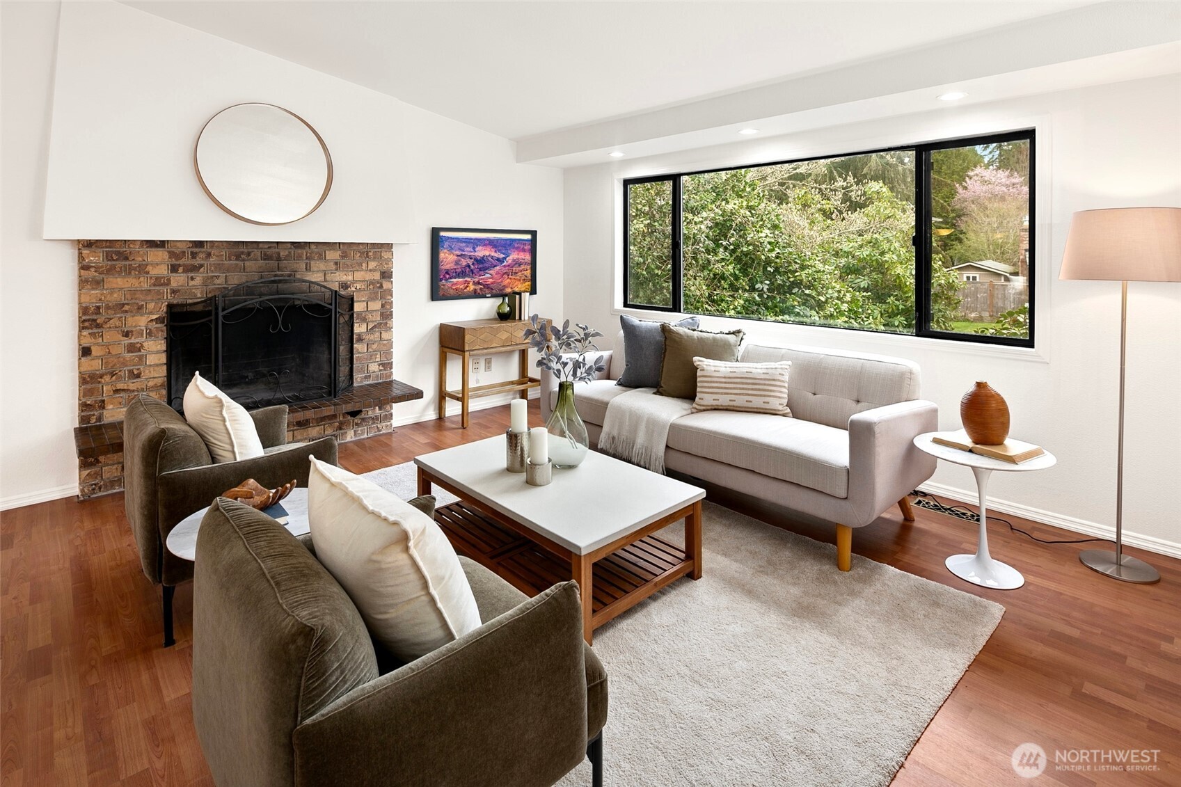 17612 Valley Cir Drive Bothell, WA 98012 - Photo 2 of 26 a living room with furniture a fireplace and a large window