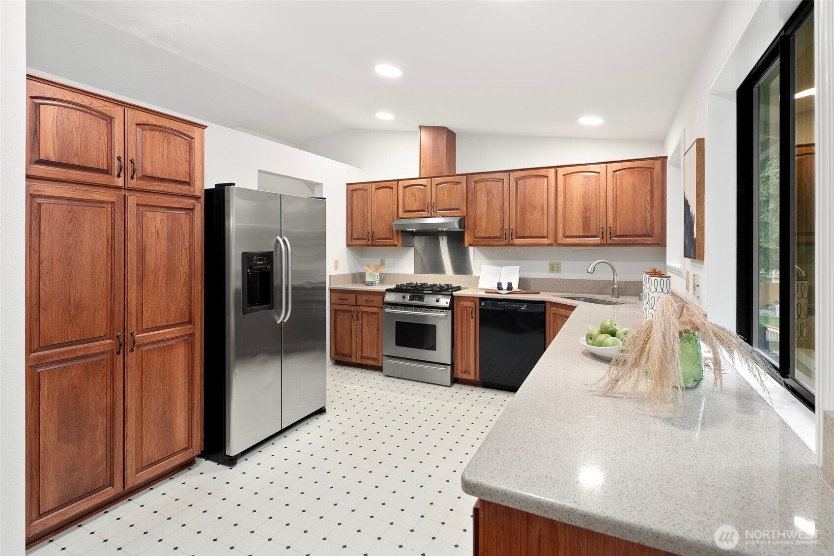 17612 Valley Cir Drive Bothell, WA 98012 - Photo 7 of 26 a kitchen with stainless steel appliances granite countertop a refrigerator a stove a sink and a microwave