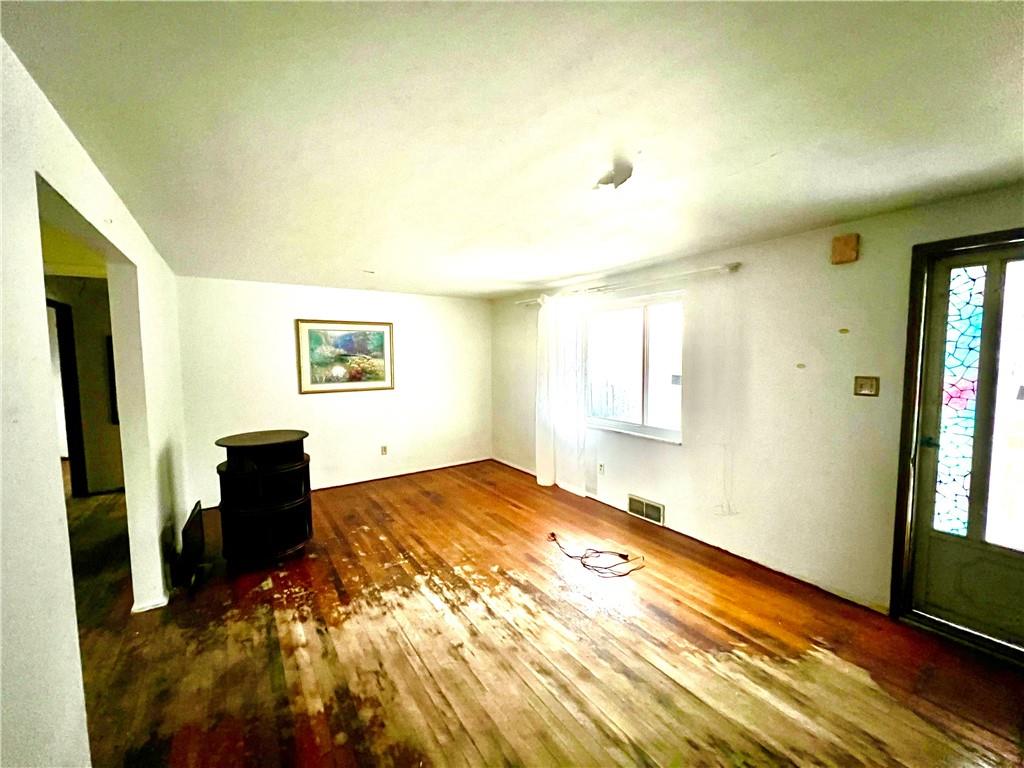 4142 Steiger Street Pittsburgh, PA 15234 - Photo 2 of 18 a bedroom with a bed and wooden floor