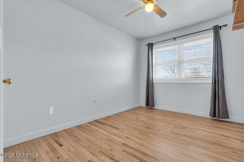 3403 Bridge Avenue, Unit 13 Point Pleasant, NJ 08742 - Photo 15 of 27 wooden floor in an empty room with a window