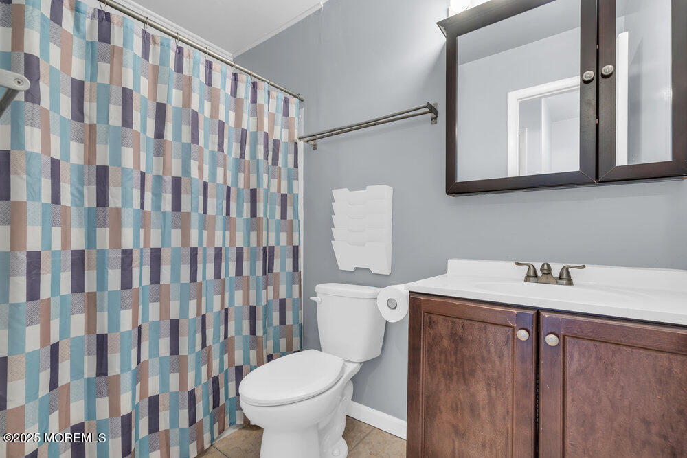 3403 Bridge Avenue, Unit 13 Point Pleasant, NJ 08742 - Photo 16 of 27 a bathroom with a sink toilet and a mirror
