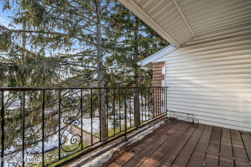 3403 Bridge Avenue, Unit 13 Point Pleasant, NJ 08742 - Photo 18 of 27 a view of a balcony with wooden floor and fence